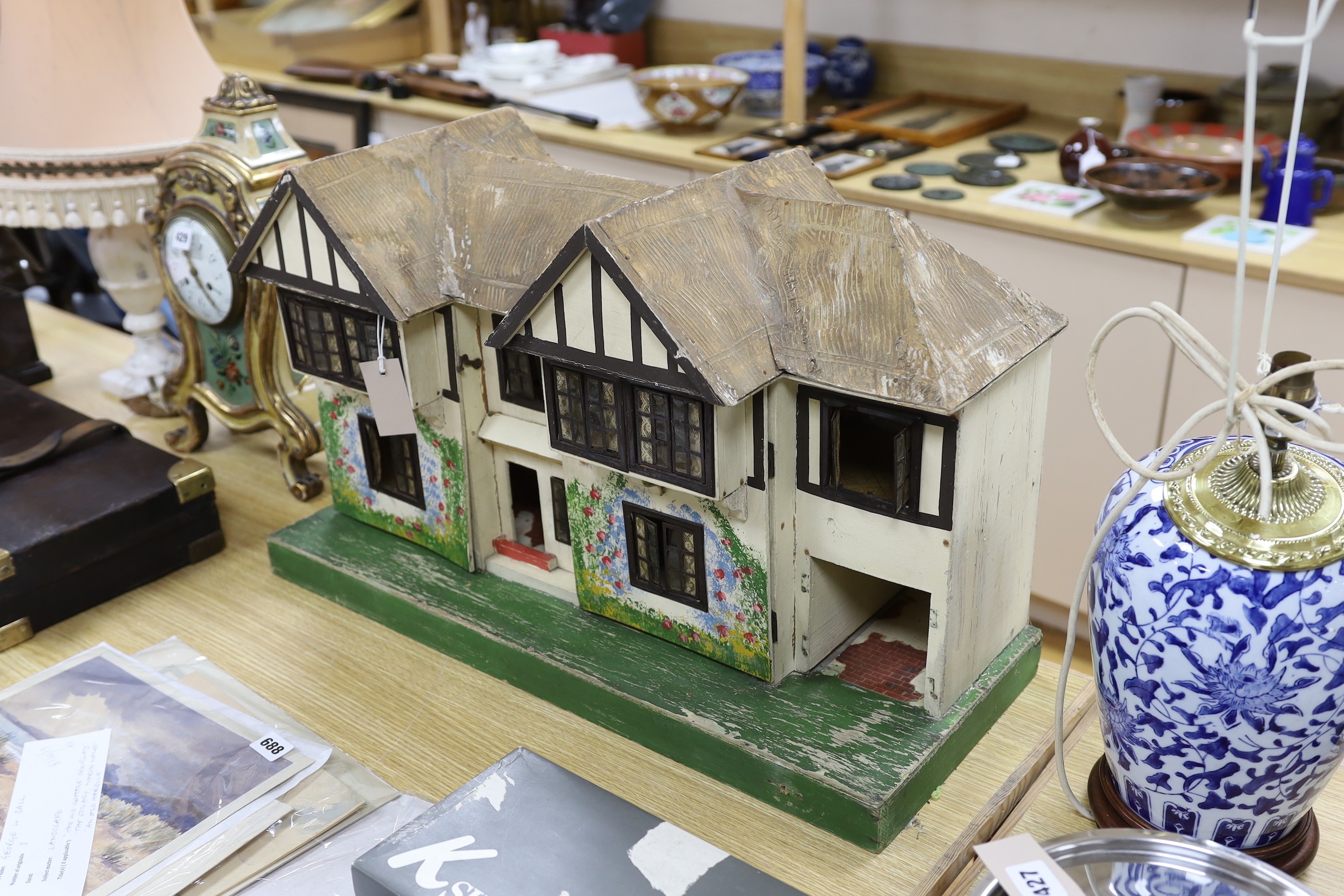 A Tri-Ang mock Tudor style doll's house and furnishings, 68cms wide, 42cms high